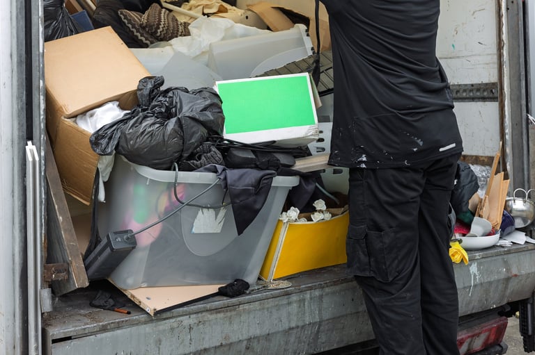 Worker unloading mixed waste from truck